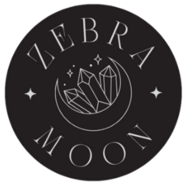 Zebra Moon logo with crystals and moon design on a black circle